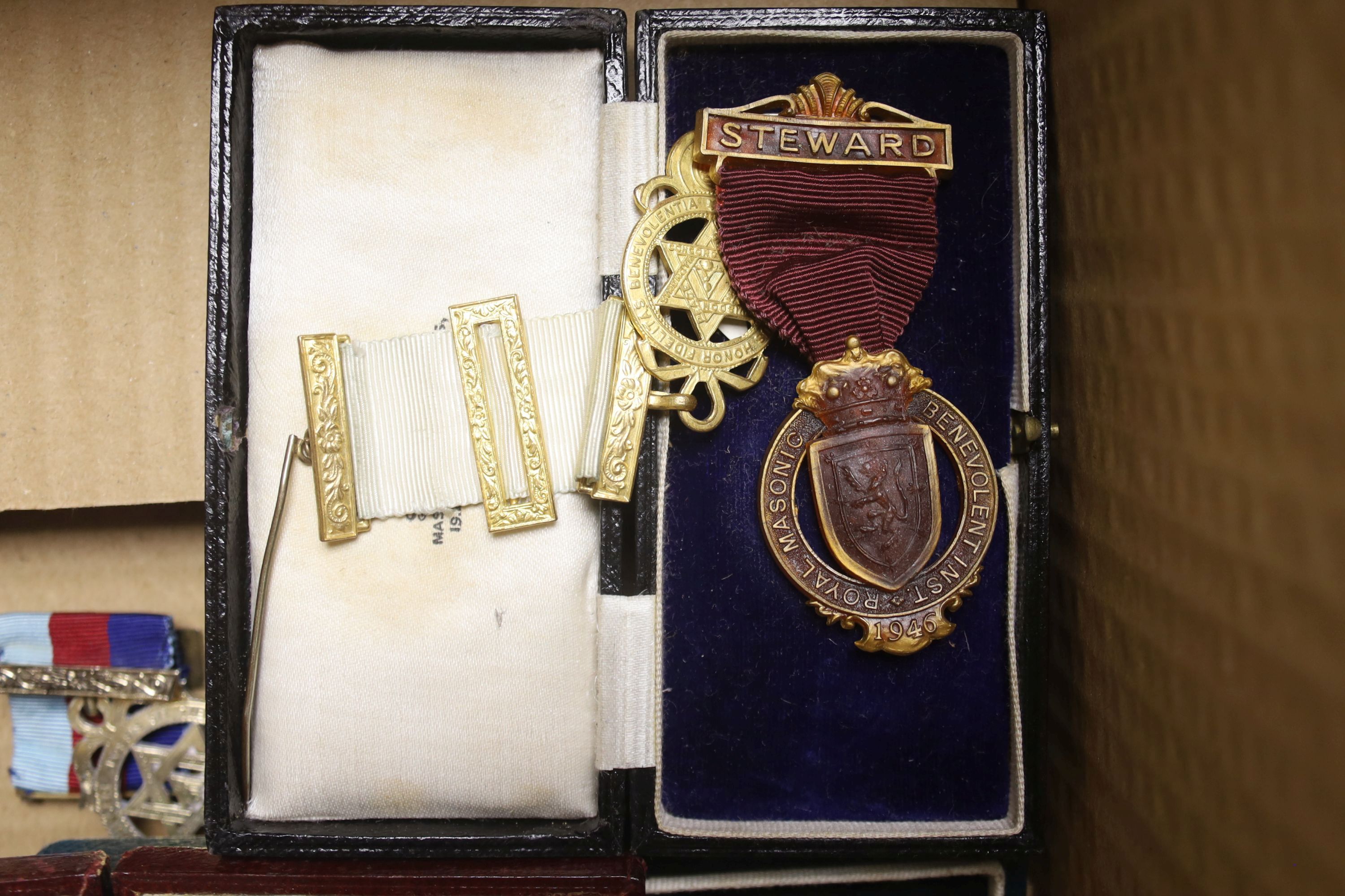 A group of Masonic sashes with metal medals and a collection of gilt metal cased medals